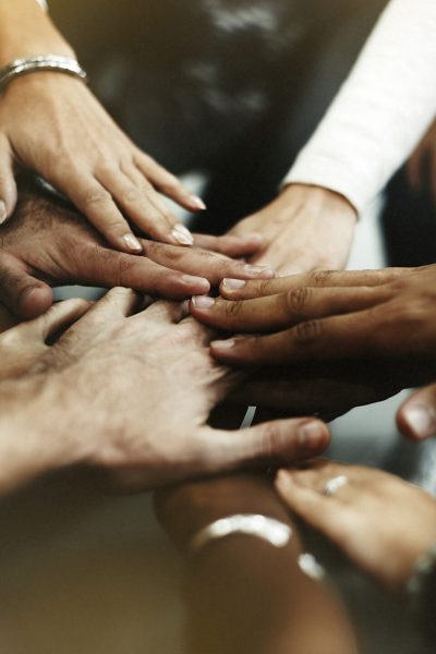 Closeup of diverse people joining their hands Closeup of diverse people joining their hands